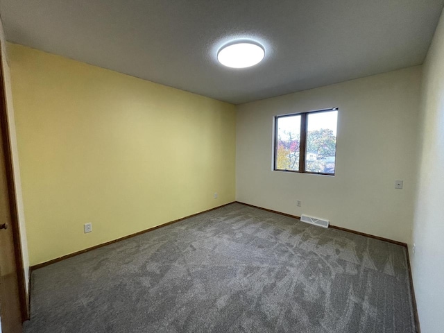 carpeted spare room featuring a textured ceiling