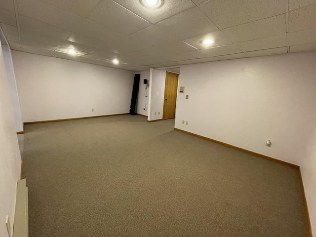 spare room with carpet flooring and a drop ceiling