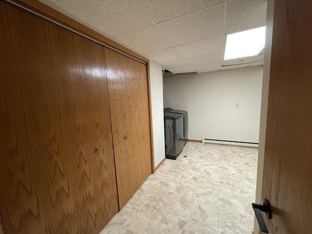 laundry area with washer and clothes dryer and a baseboard heating unit