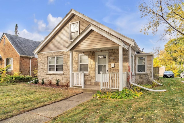 view of front of home with a porch and a front lawn