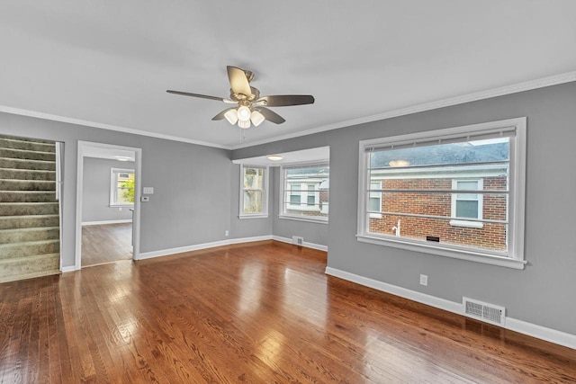 spare room featuring ornamental molding, hardwood / wood-style flooring, plenty of natural light, and ceiling fan