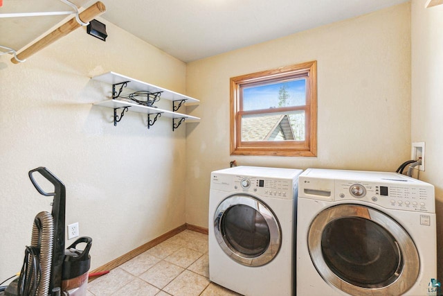 laundry area featuring independent washer and dryer and light tile patterned flooring