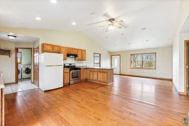 kitchen with washer and clothes dryer, light hardwood / wood-style flooring, kitchen peninsula, stainless steel gas range oven, and white fridge