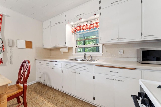 kitchen featuring white cabinets and sink