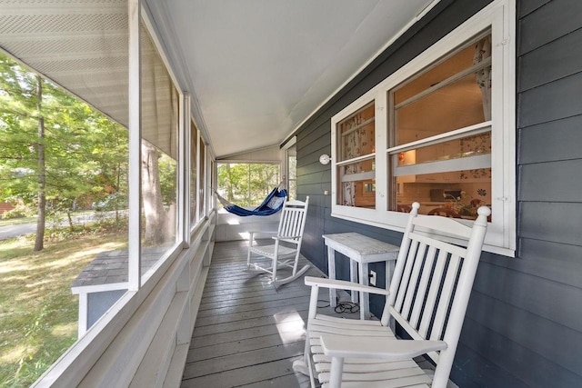 sunroom / solarium featuring lofted ceiling