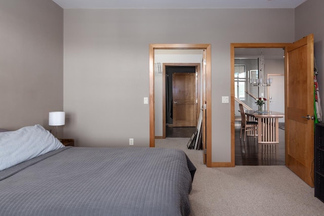 bedroom featuring carpet and an inviting chandelier