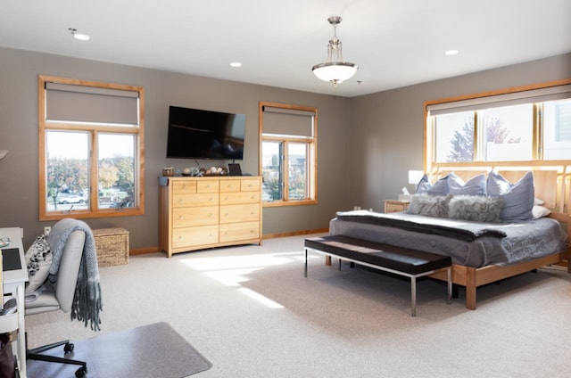 bedroom featuring light carpet and multiple windows