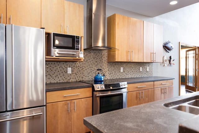 kitchen with wall chimney range hood, decorative backsplash, and stainless steel appliances