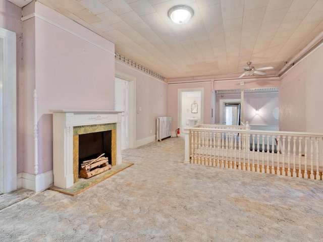 360 1st St, Menasha, WI 54952 - unfurnished living room with carpet flooring, a high end fireplace, a ceiling fan, and radiator heating unit