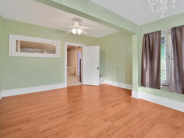 360 1st St, Menasha, WI 54952 - empty room featuring baseboards, wood finished floors, and a ceiling fan