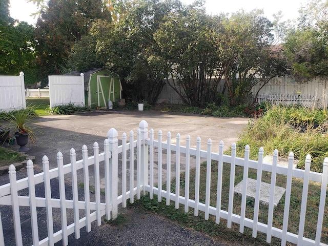 view of yard with a storage unit, fence private yard, and an outbuilding