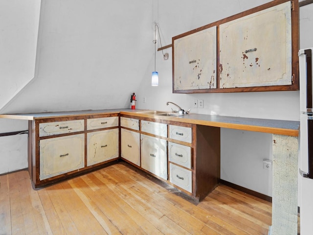 360 1st St, Menasha, WI 54952 - kitchen featuring light wood-style floors, a sink, light countertops, and decorative light fixtures