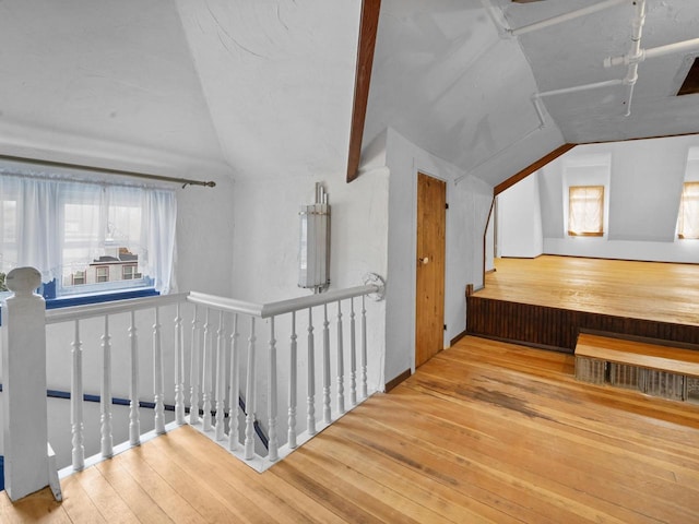 additional living space with vaulted ceiling and hardwood / wood-style flooring