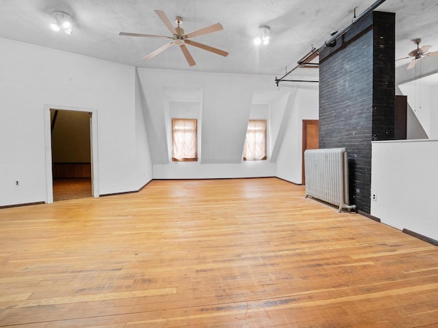 360 1st St, Menasha, WI 54952 - unfurnished living room with a ceiling fan, light wood-type flooring, and radiator