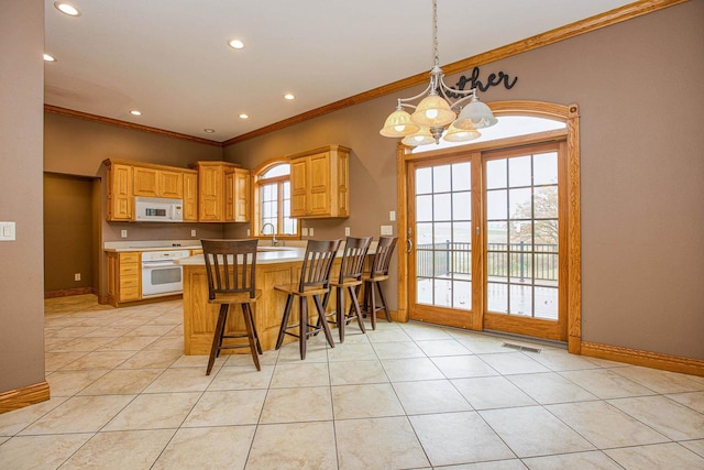 kitchen with white appliances, pendant lighting, light tile patterned flooring, and kitchen peninsula