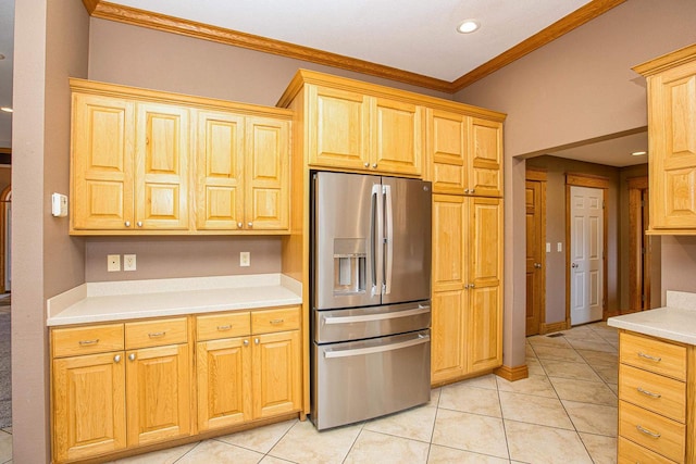 kitchen with ornamental molding, stainless steel fridge with ice dispenser, and light tile patterned flooring