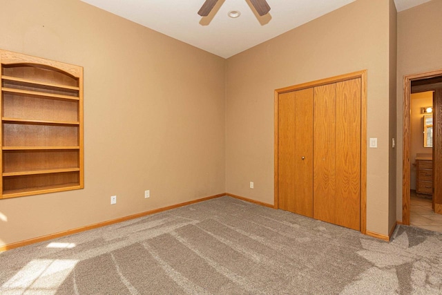 unfurnished bedroom with light colored carpet, a closet, and ceiling fan