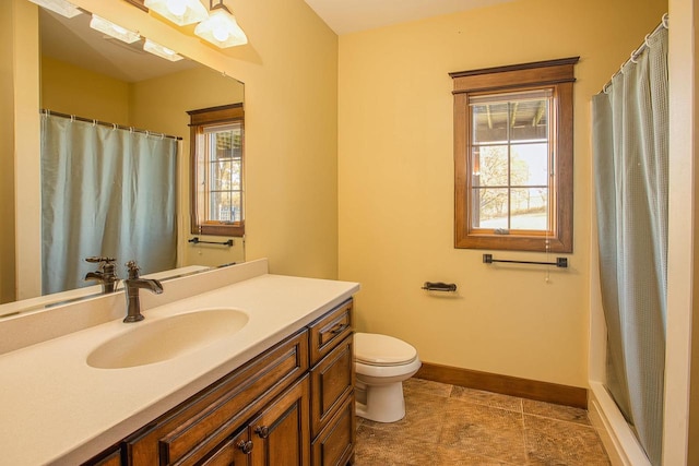 bathroom featuring toilet, walk in shower, vanity, and tile patterned floors