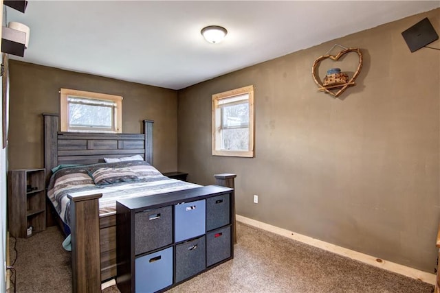 bedroom with multiple windows and light colored carpet