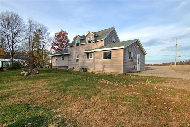 back of house with a yard