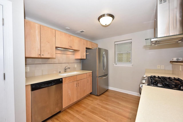 kitchen featuring light hardwood / wood-style floors, stainless steel appliances, extractor fan, and light brown cabinets