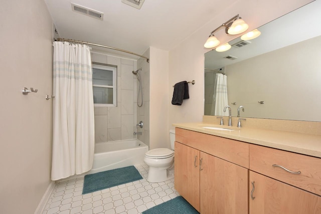 full bathroom featuring vanity, shower / bath combo with shower curtain, toilet, and tile patterned floors