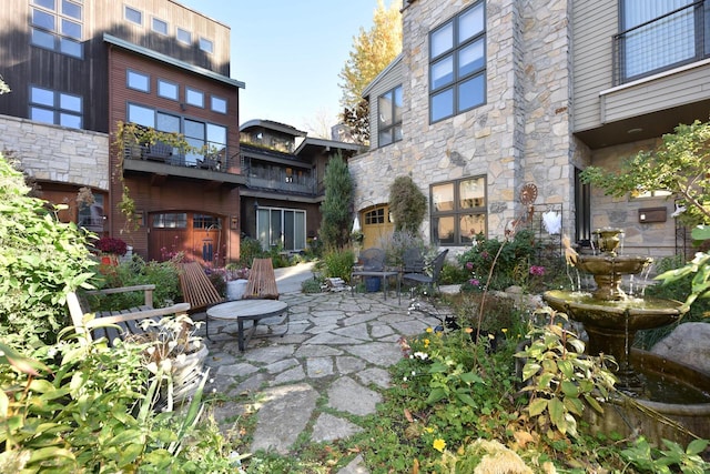 view of patio featuring a balcony