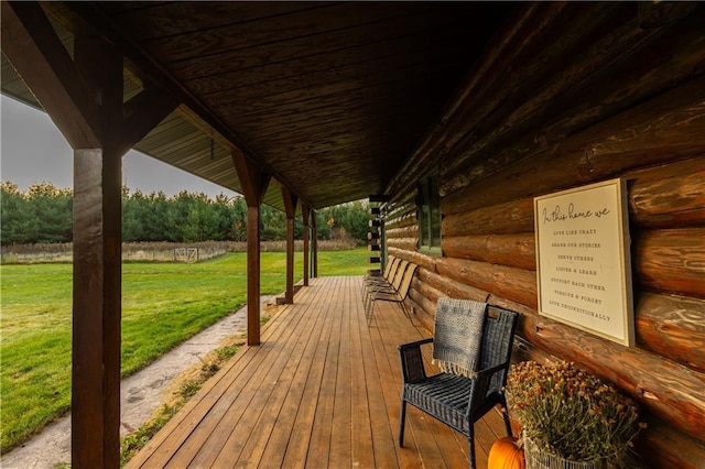 wooden deck featuring a lawn