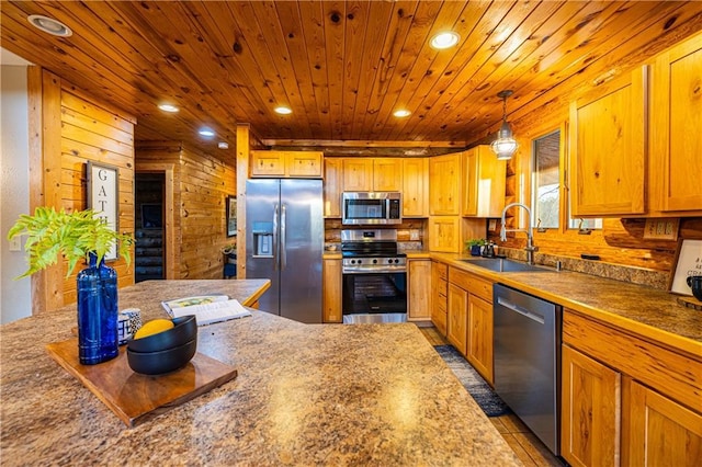 kitchen with wood walls, sink, wood ceiling, hanging light fixtures, and stainless steel appliances