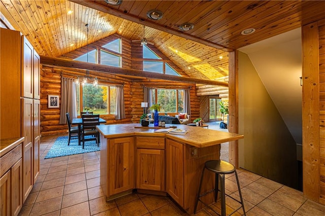 kitchen with hanging light fixtures, a center island, wooden ceiling, and log walls