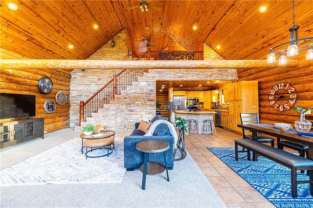 living room featuring ceiling fan, high vaulted ceiling, wooden ceiling, and rustic walls