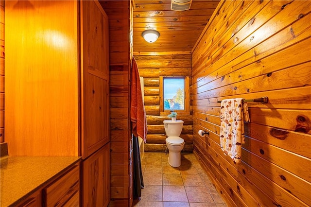 bathroom with toilet, tile patterned floors, and wood ceiling