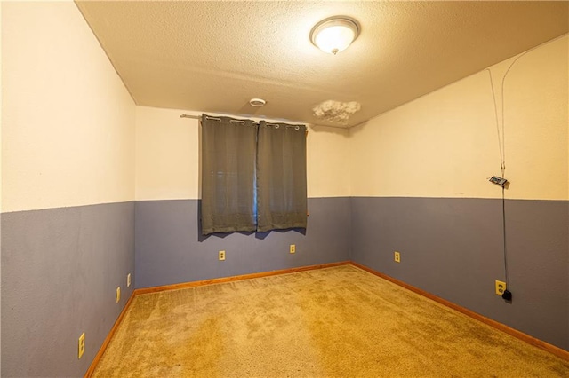 carpeted empty room with a textured ceiling