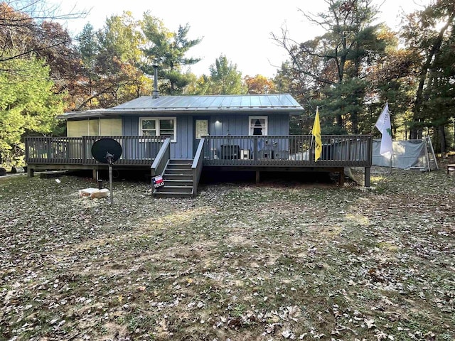 rear view of house featuring a wooden deck