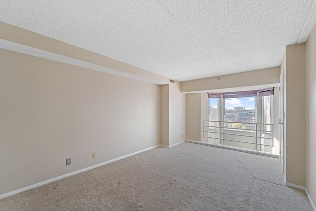 carpeted spare room featuring a textured ceiling