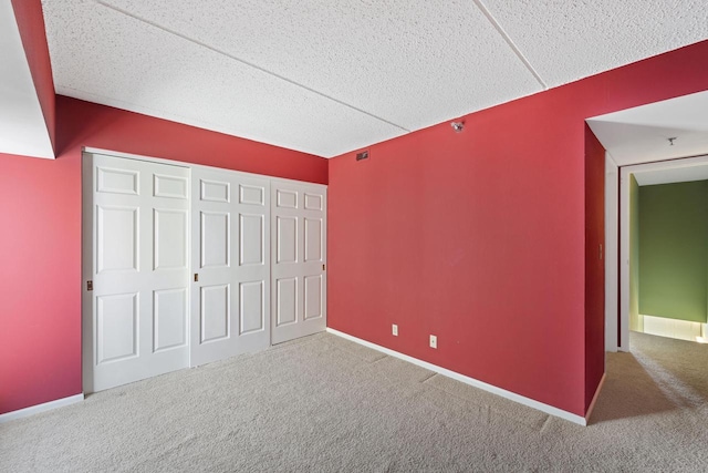 unfurnished bedroom featuring carpet flooring and a closet