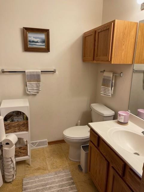 bathroom featuring vanity, toilet, and tile patterned flooring