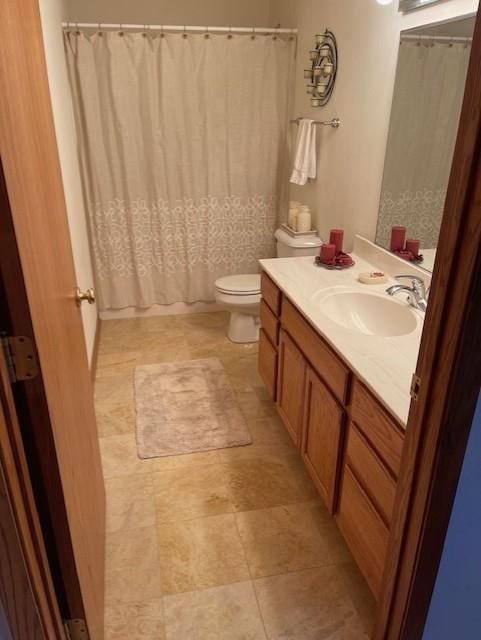 bathroom featuring vanity, walk in shower, and toilet