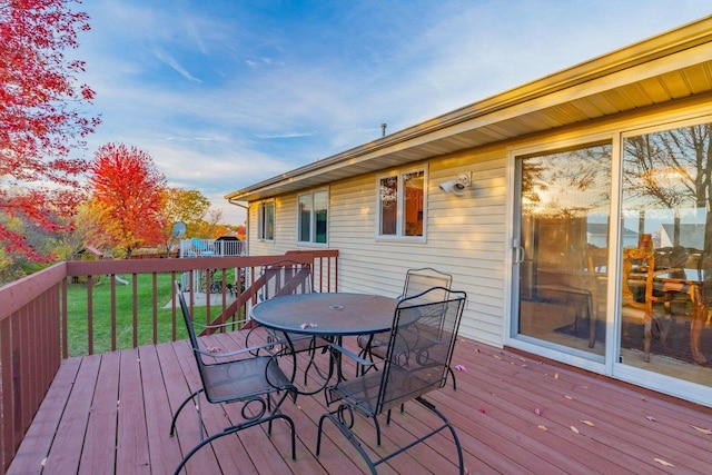 wooden deck with a lawn