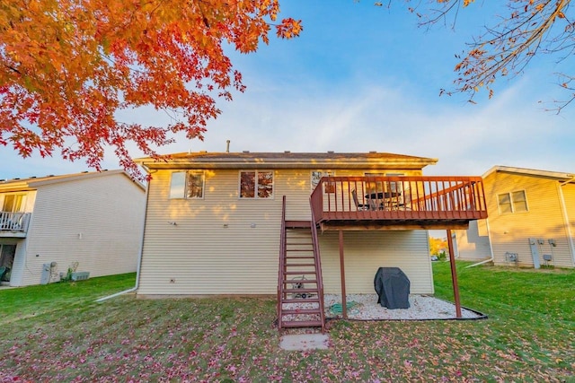 back of house with a yard and a wooden deck