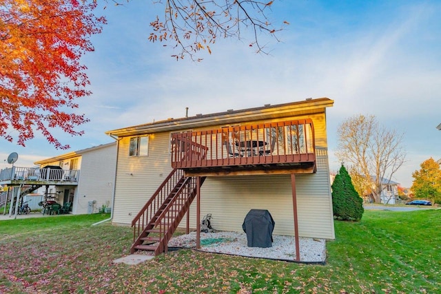 rear view of house featuring a yard and a deck