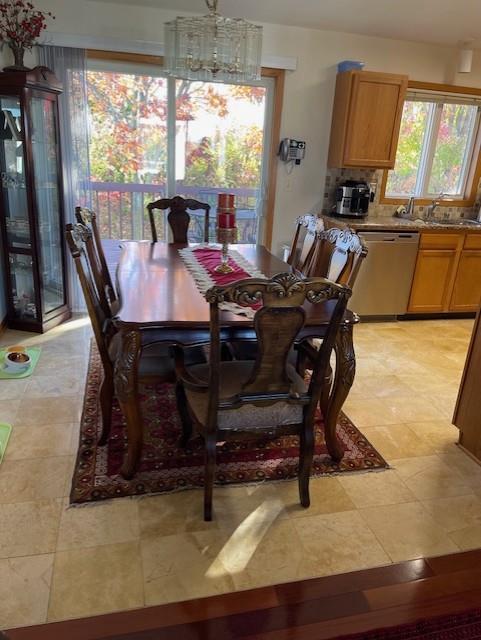 dining room with sink and a chandelier