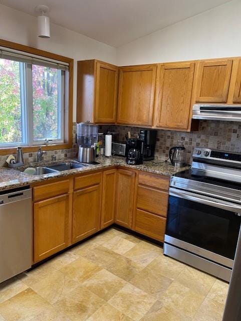 kitchen with tasteful backsplash, sink, stainless steel appliances, vaulted ceiling, and exhaust hood