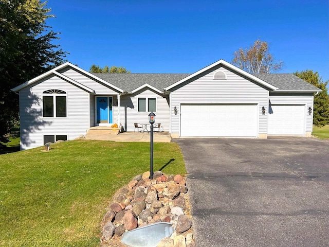 6848 Moonlight Cir, Sun Prairie, WI 53590 - ranch-style home with an attached garage, asphalt driveway, a front lawn, and roof with shingles