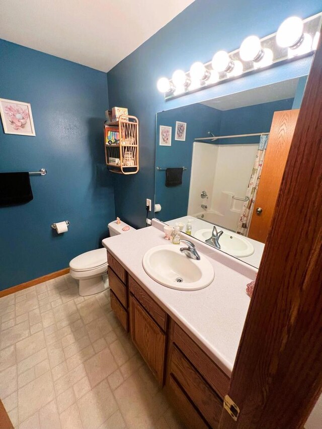 bathroom featuring vanity, toilet, and curtained shower