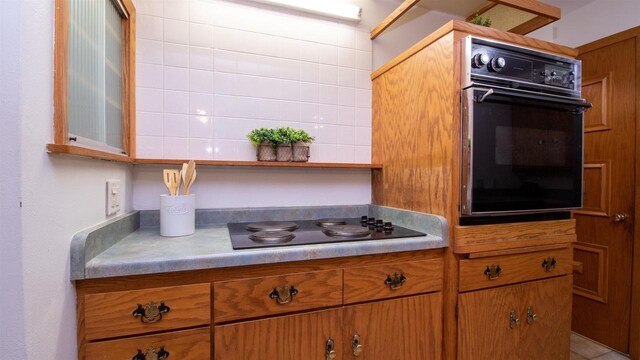 kitchen with decorative backsplash and black appliances