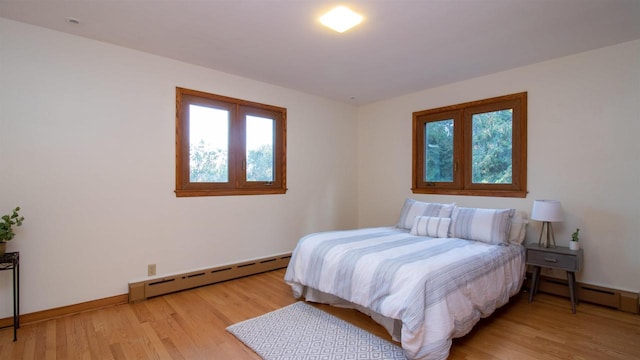 bedroom featuring light hardwood / wood-style floors and a baseboard radiator