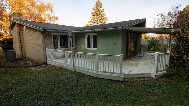 rear view of house with a yard and a deck