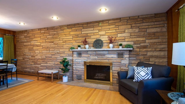 living room with hardwood / wood-style floors and a fireplace