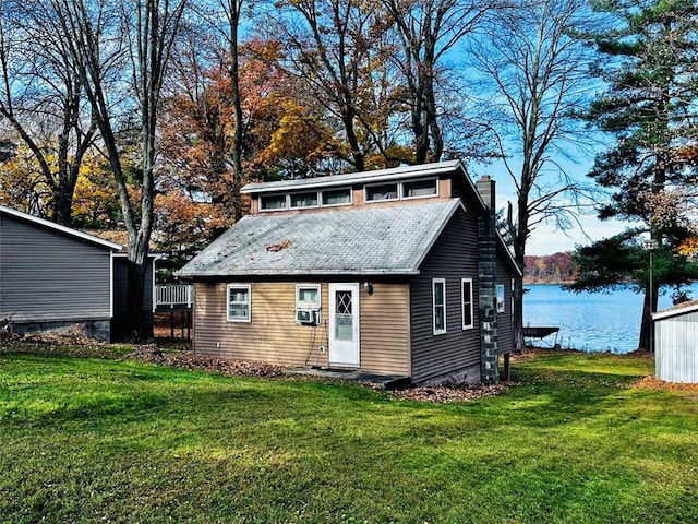 view of front of house featuring a water view, a front yard, and cooling unit